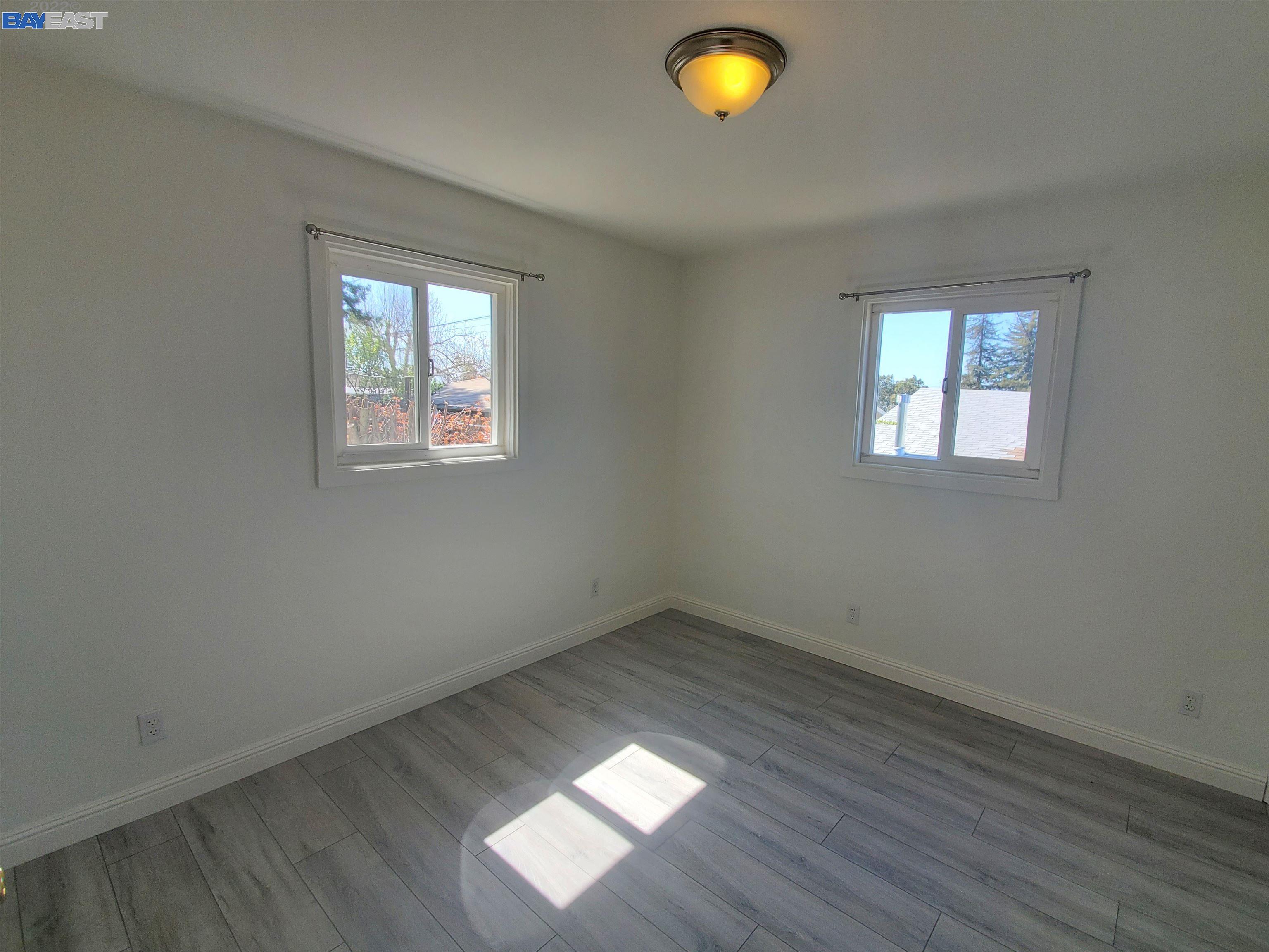 1869 E Street Hayward, CA 94541 - Photo 8 of 22 an empty room with wooden floor and windows