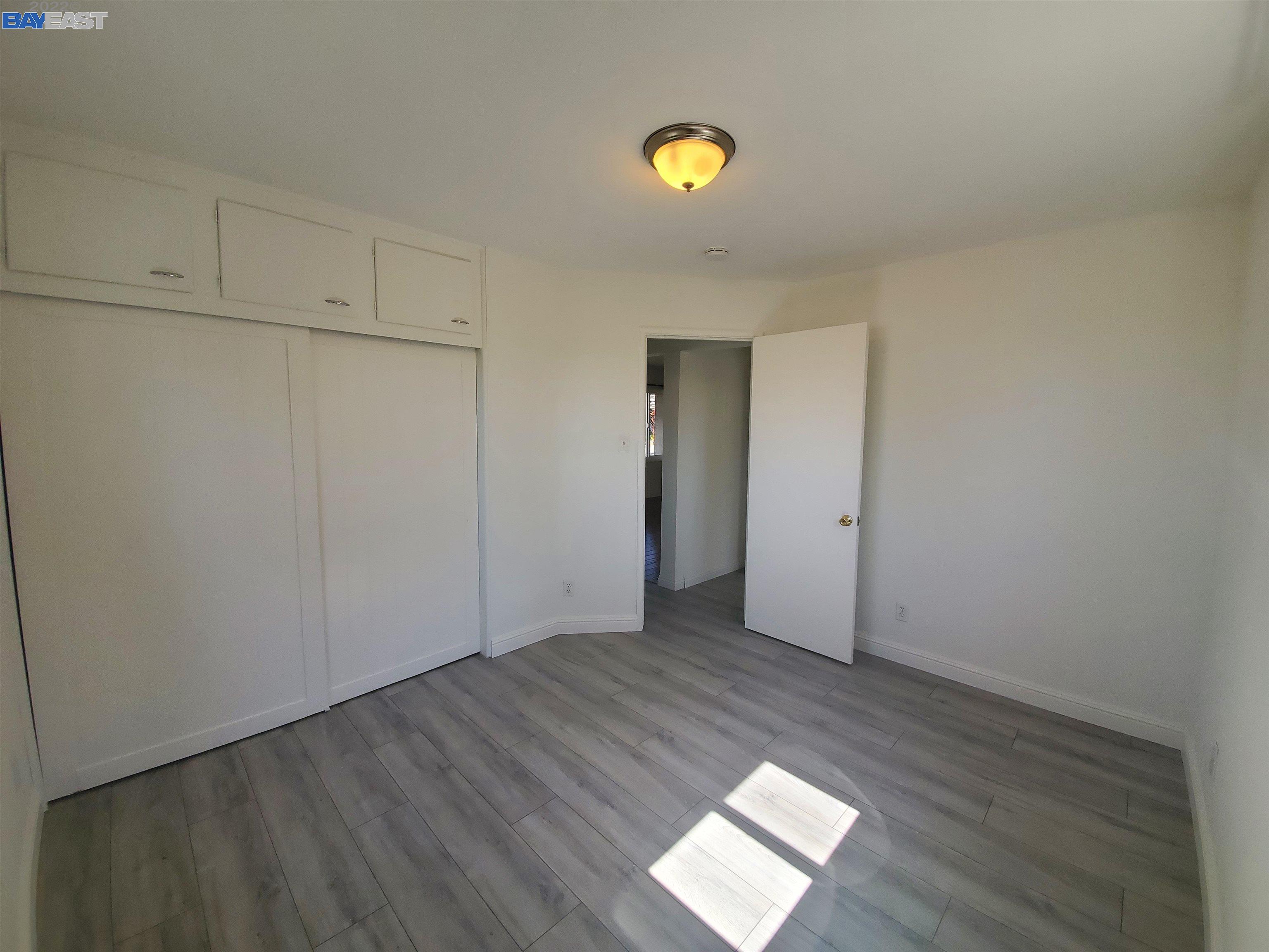 1869 E Street Hayward, CA 94541 - Photo 9 of 22 an empty room with wooden floor and closet