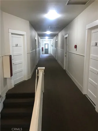 a view of entryway bedroom and hall with wooden floor