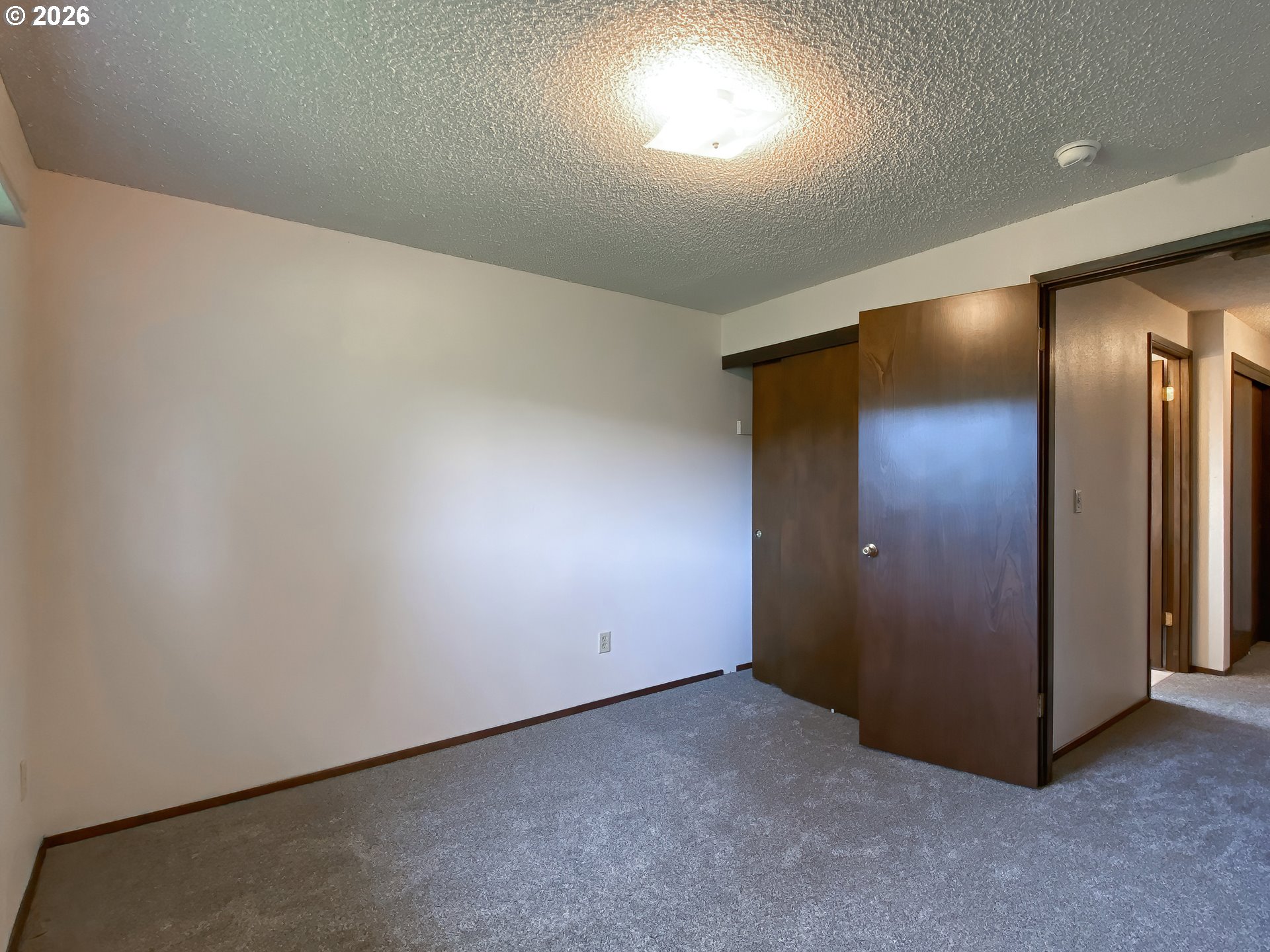 710 Northeast 5th Street Willamina, OR 97396 - Photo 15 of 18 an empty room with closet and mirror