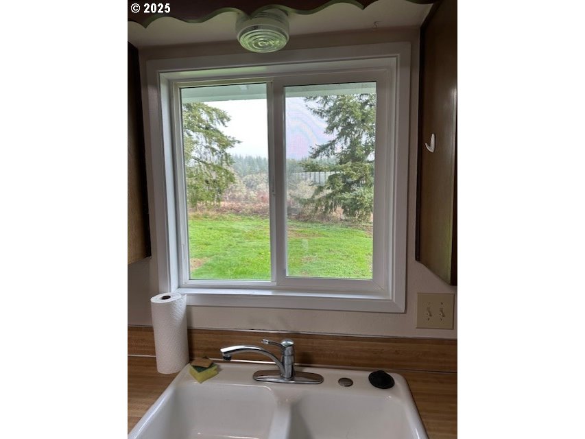 710 Northeast 5th Street Willamina, OR 97396 - Photo 5 of 18 a bathroom with a sink and a window