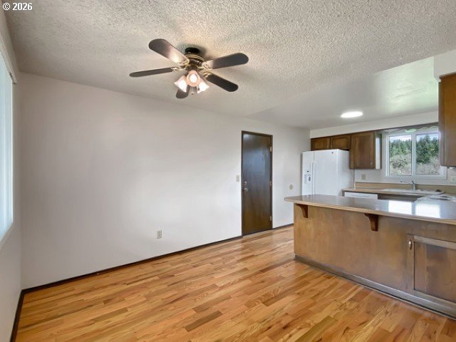 710 Northeast 5th Street Willamina, OR 97396 - Photo 8 of 18 a view of kitchen with sink and wooden floor