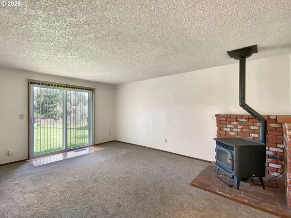 a view of an empty room with a fireplace