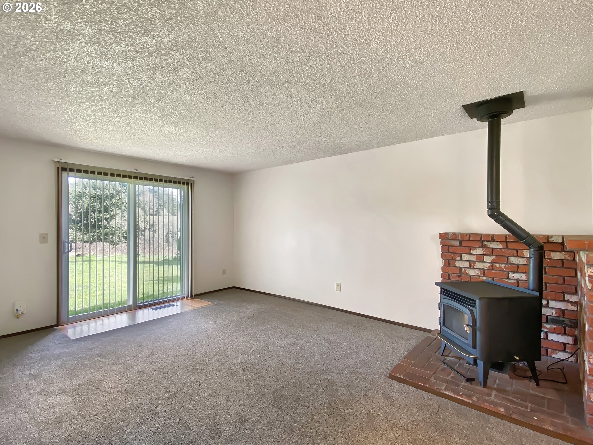 710 Northeast 5th Street Willamina, OR 97396 - Photo 10 of 18 a view of an empty room with a fireplace