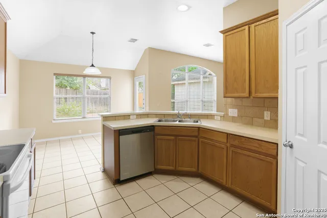 a kitchen with a sink and a refrigerator