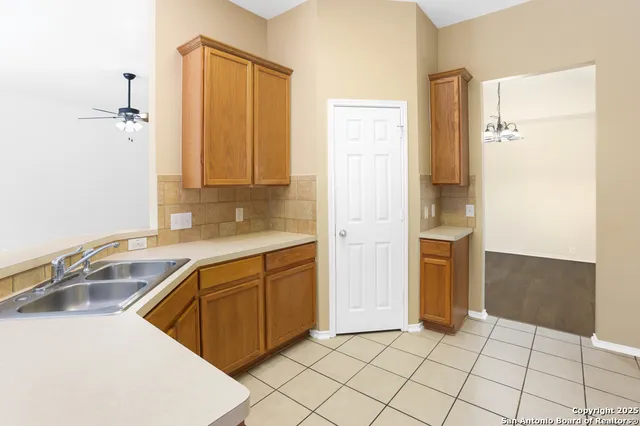 a kitchen with stainless steel appliances a stove a sink a microwave a refrigerator and cabinets