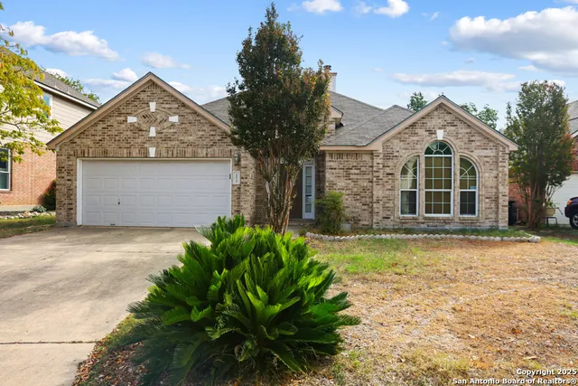 a front view of a house with a garden and yard