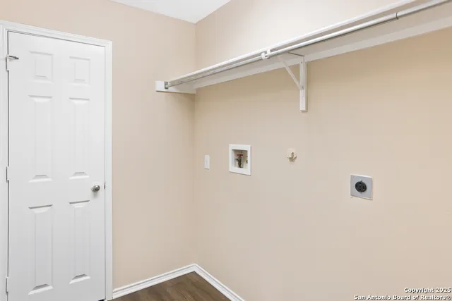 a view of backyard of house with wooden fence