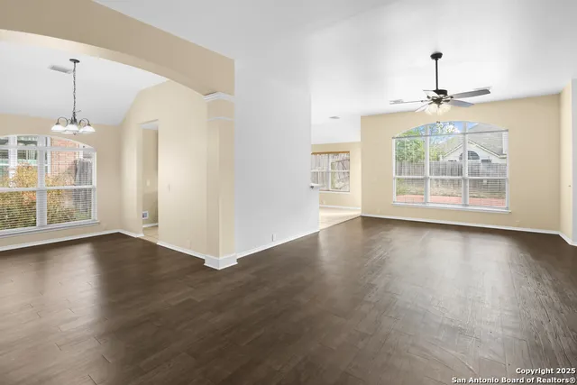 a view of a livingroom with a fireplace wooden floor and chandelier