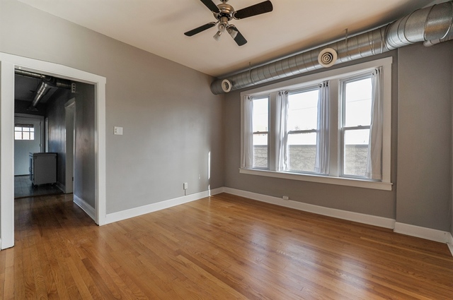 2012 West Haddon Avenue, Unit 3 Chicago, IL 60622 - Photo 4 of 12 a view of an empty room with wooden floor and a window