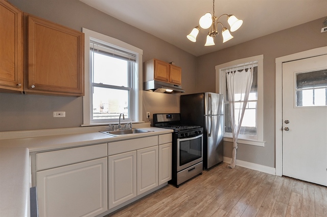 2012 West Haddon Avenue, Unit 3 Chicago, IL 60622 - Photo 6 of 12 a kitchen with stainless steel appliances granite countertop a sink and a stove