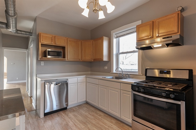 2012 West Haddon Avenue, Unit 3 Chicago, IL 60622 - Photo 7 of 12 a kitchen with stainless steel appliances granite countertop a stove microwave and sink