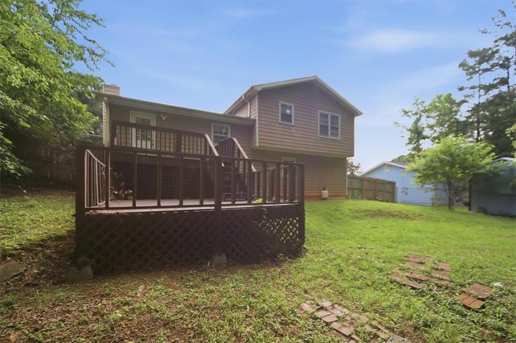 1496 Cherry Hill Road Southwest Conyers, GA 30094 - Photo 28 of 32 a view of a house with backyard and garden
