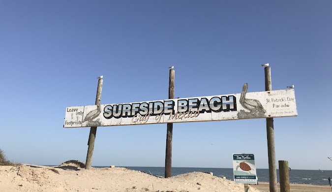 432 Angel Wing Street Surfside Beach, TX 77541 - Photo 3 of 4 a street sign on a wall next to a road