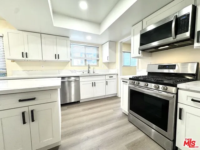 a kitchen with stainless steel appliances granite countertop a stove and a sink