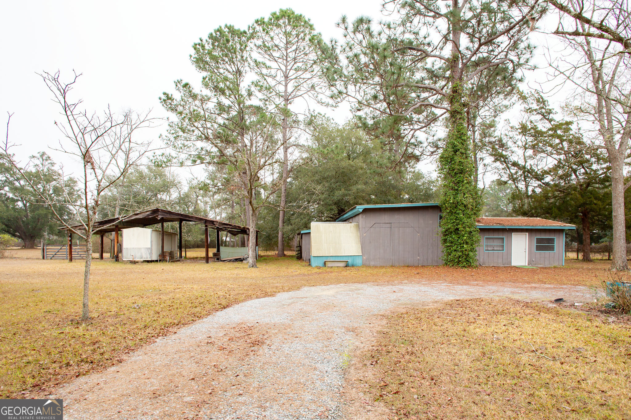 4618 Old Waltertown Road Waycross, GA 31503 - Photo 6 of 39 a house with trees in front of it