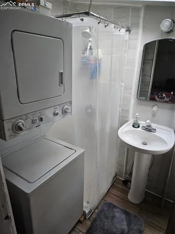 a bathroom with a sink a toilet a mirror and shower