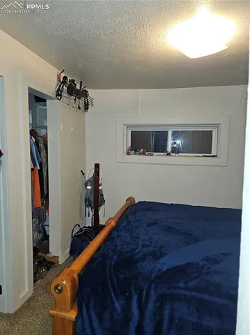 a bed room with a bed and a mirror