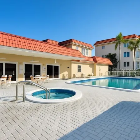 a front view of a house with swimming pool and dining room
