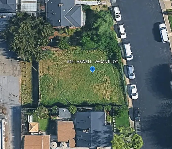 an aerial view of a residential houses with outdoor space