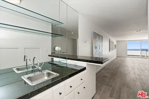 a view of a kitchen with a sink and living room