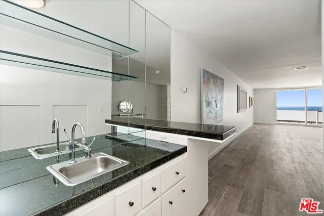 a view of a kitchen with a sink and living room