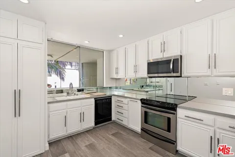 a kitchen with a sink stove and microwave