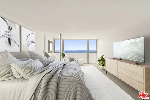 a bedroom with a large bed and a flat screen tv