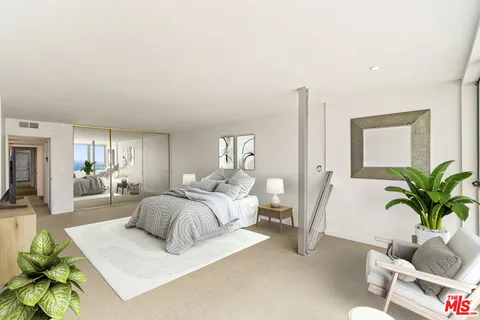 a bedroom with furniture and a potted plant