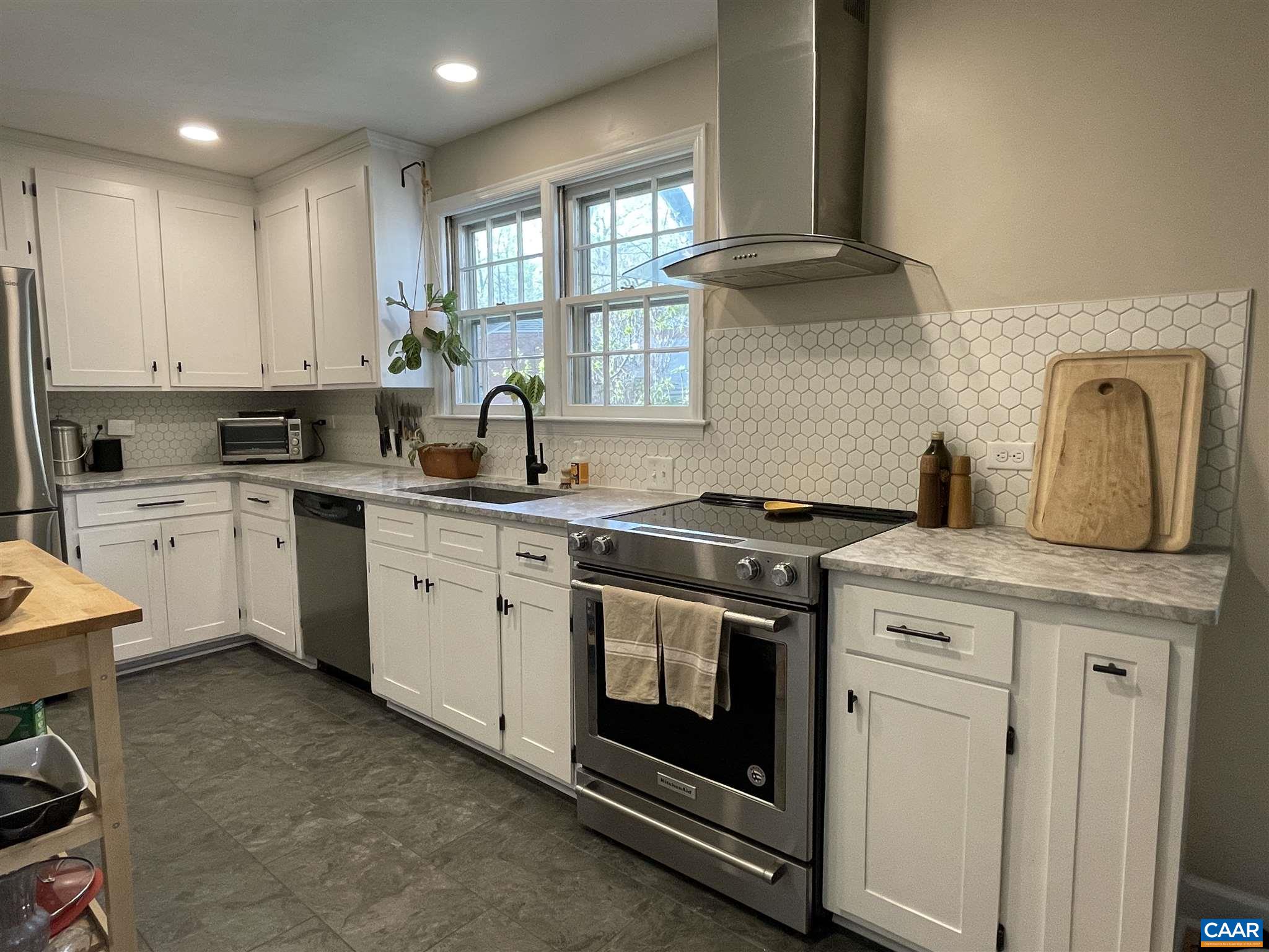 2403 Brook Road Charlottesville, VA 22901 - Photo 5 of 18 a kitchen with stainless steel appliances granite countertop a stove a sink and a microwave