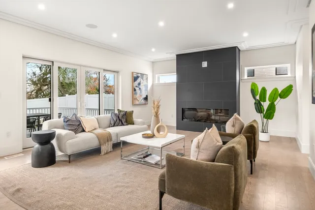 a living room with furniture a fireplace and a table