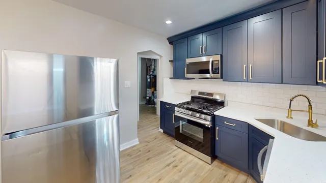 a kitchen with a refrigerator and cabinets