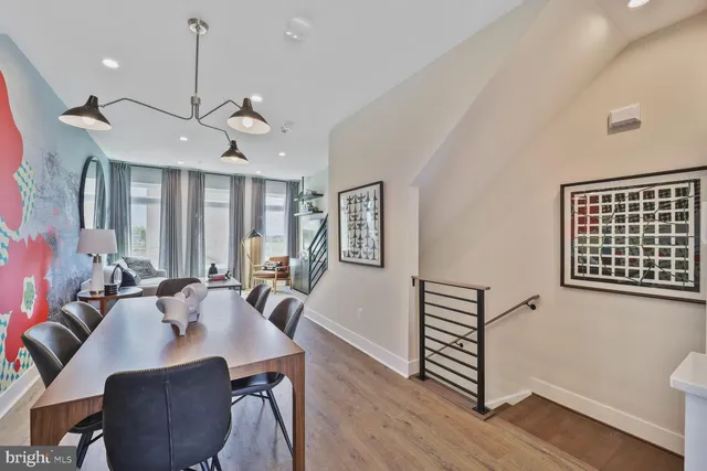 a view of a a dining room with furniture window and wooden floor