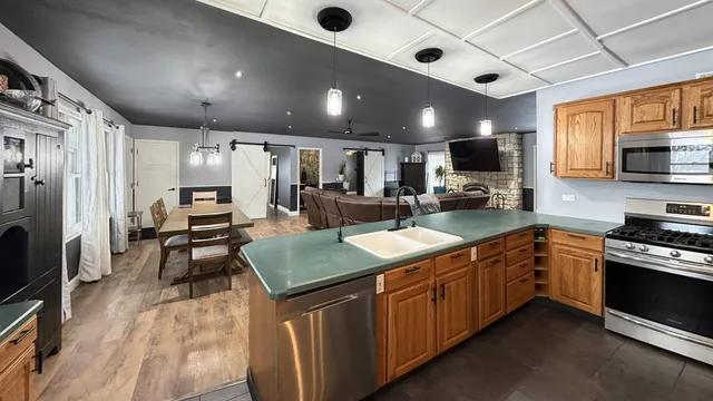 a kitchen with sink cabinets and stainless steel appliances