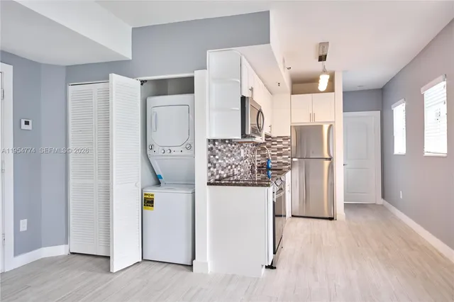 a kitchen with stainless steel appliances a refrigerator and a stove