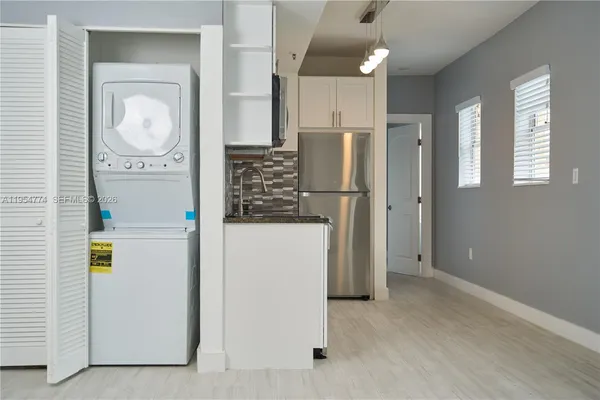 a view of a hallway with washer and dryer
