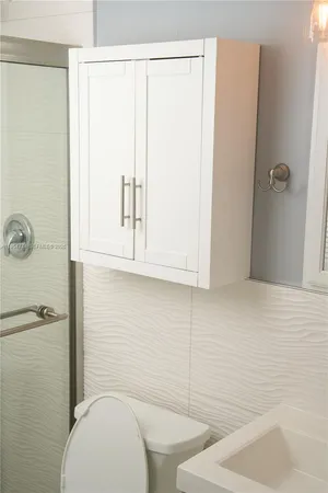 a bathroom with a toilet and a shower