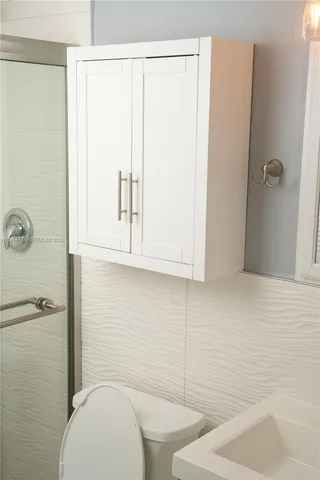 a bathroom with a toilet and a shower