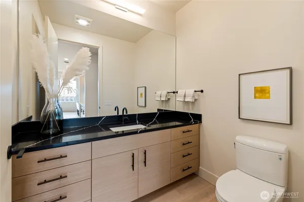 a bathroom with a granite countertop sink and a mirror