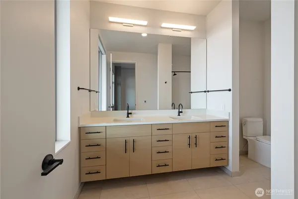 a bathroom with a double vanity sink double and mirror