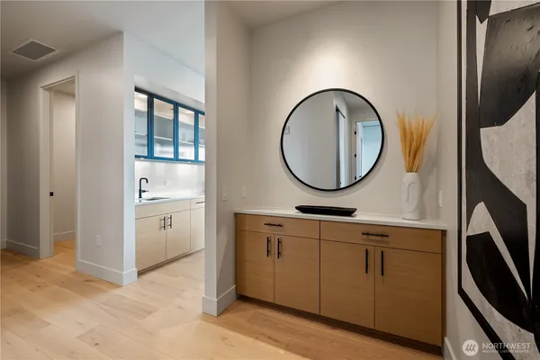 a bathroom with a sink a mirror and a shower