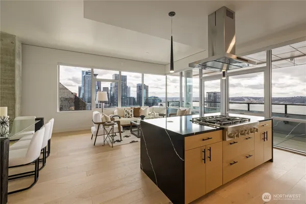 a very nice looking living room with a large window and dining table