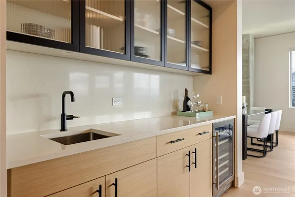 a kitchen with stainless steel appliances granite countertop white cabinets and a sink