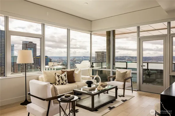 a living room with furniture and a floor to ceiling window