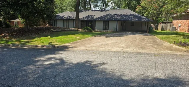 a front view of a house with a yard and a garage