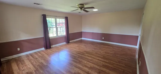 a view of empty room with a fireplace