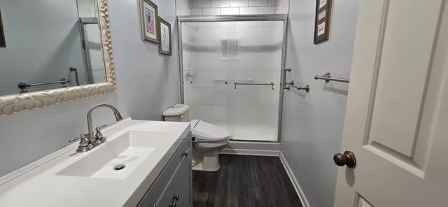 a bathroom with a sink toilet and shower