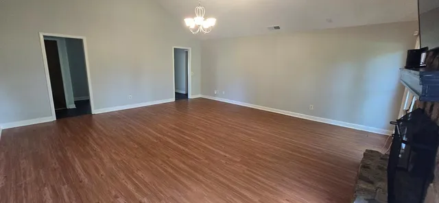 wooden floor in an empty room with a mirror