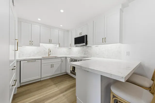 a view of a swimming pool with outdoor seating and a patio