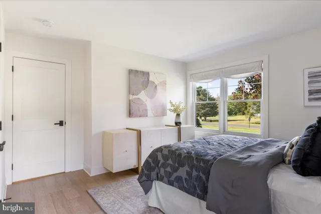 a living room with furniture and floor to ceiling windows